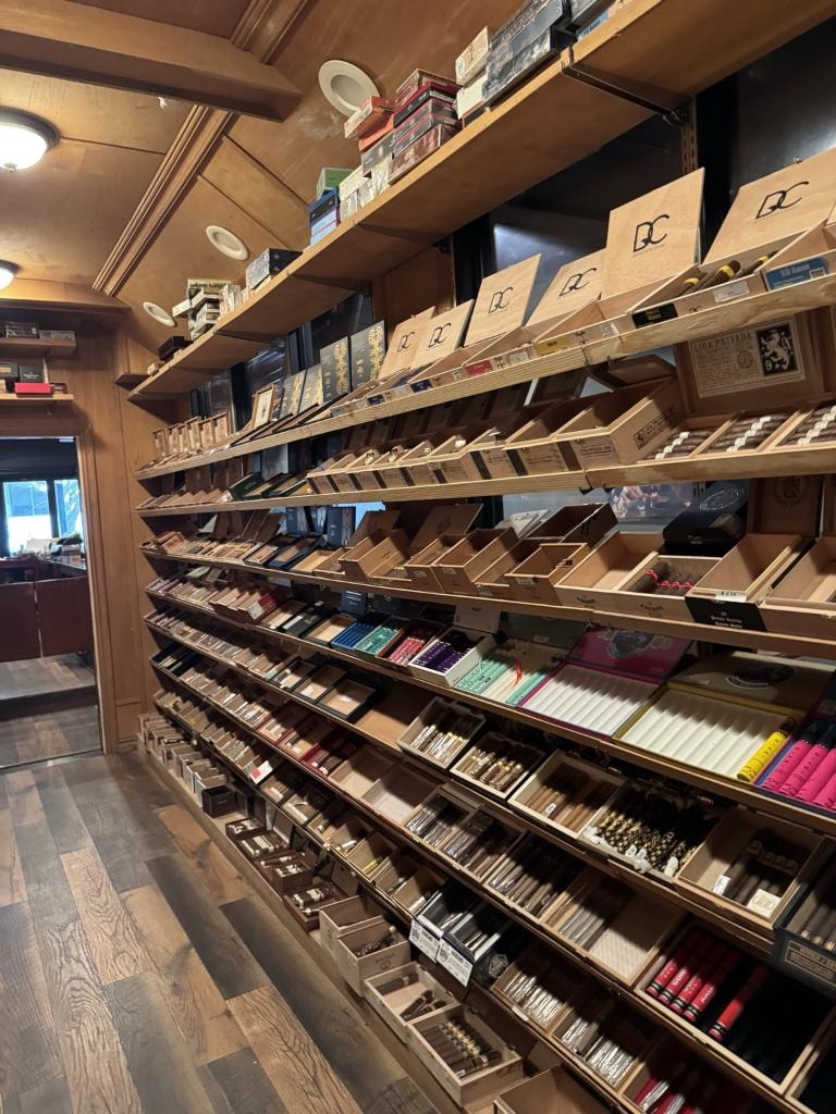 Downtown Cigar Company humidor interior showing organized cigar selection on wooden shelves